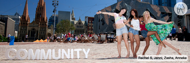 Four girlfriends in summer clothes hold each other by the waist and kick out.