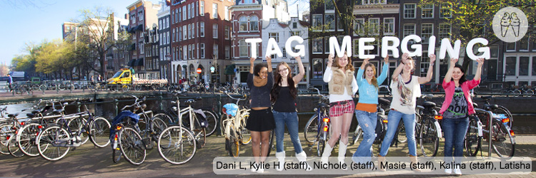 Six girls all in a row, with their arms in the air, in public.